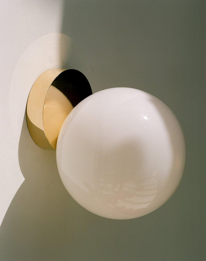 Tip of the Tongue Gold Metal Wall Sconce with White Glass Shade