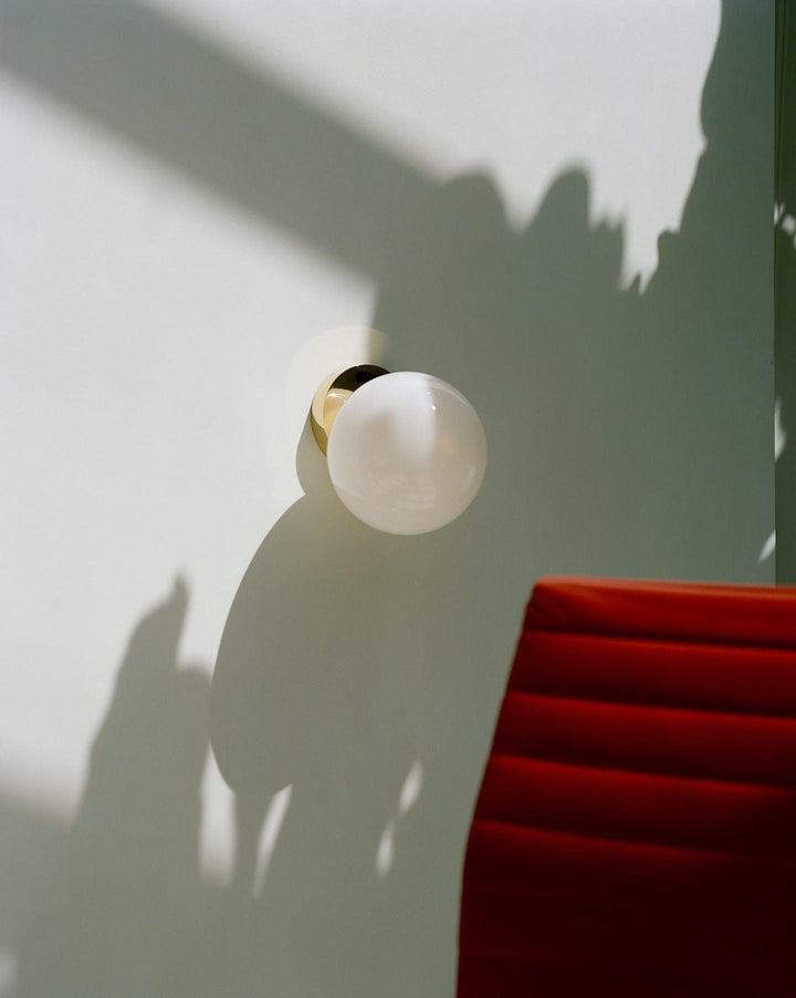 Tip of the Tongue Gold Metal Wall Sconce with White Glass Shade