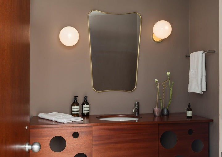 Tip of the Tongue Gold Metal Wall Sconce with White Glass Shade