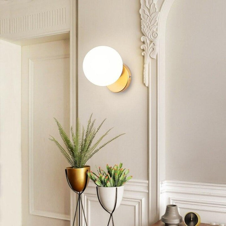Tip of the Tongue Gold Metal Wall Sconce with White Glass Shade