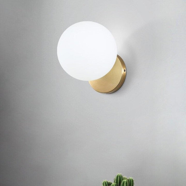 Tip of the Tongue Gold Metal Wall Sconce with White Glass Shade