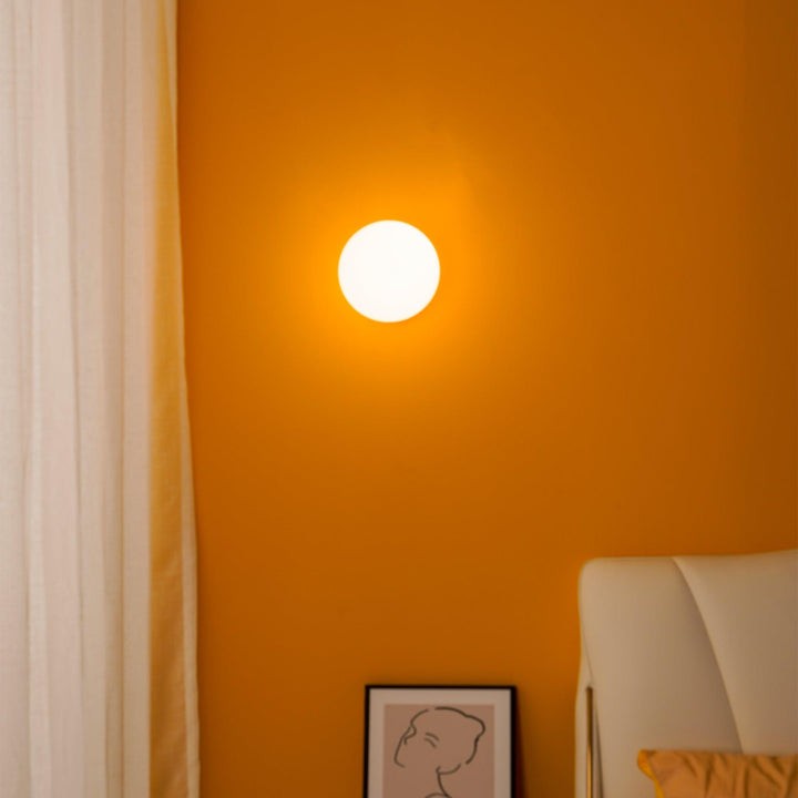 Tip of the Tongue Gold Metal Wall Sconce with White Glass Shade