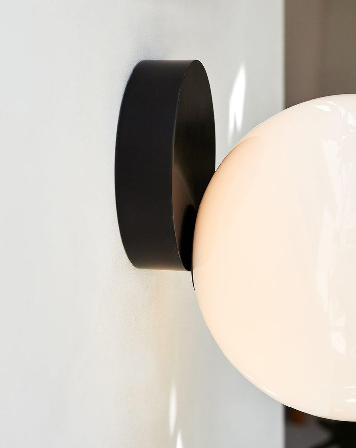 Tip of the Tongue Gold Metal Wall Sconce with White Glass Shade