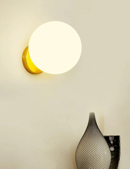 Tip of the Tongue Gold Metal Wall Sconce with White Glass Shade