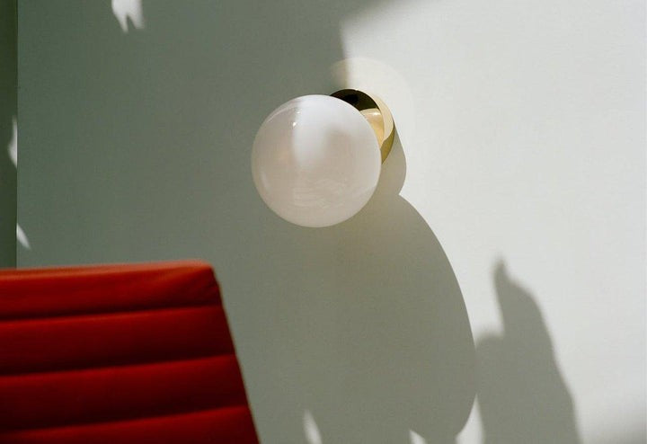 Tip of the Tongue Gold Metal Wall Sconce with White Glass Shade