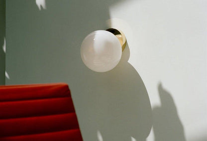 Tip of the Tongue Gold Metal Wall Sconce with White Glass Shade