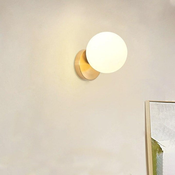 Tip of the Tongue Gold Metal Wall Sconce with White Glass Shade